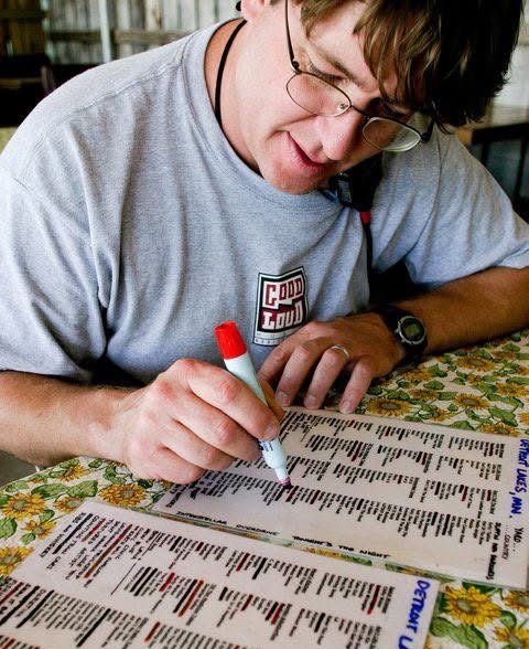 Garrie Vereen marking the color-coded master song list by hand with a red marker
